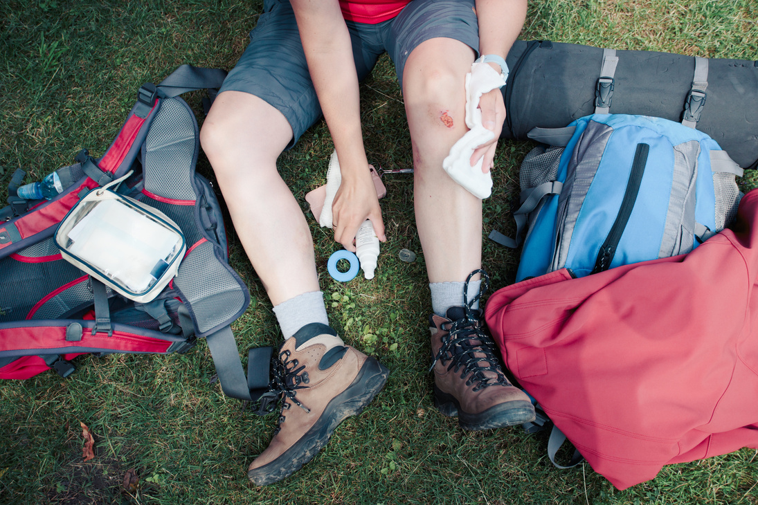 Woman Dressing the Wound on Her Knee on Hike